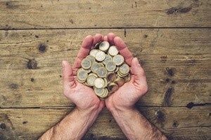 man hands holding a stack of euro coins, top view, with copy space
